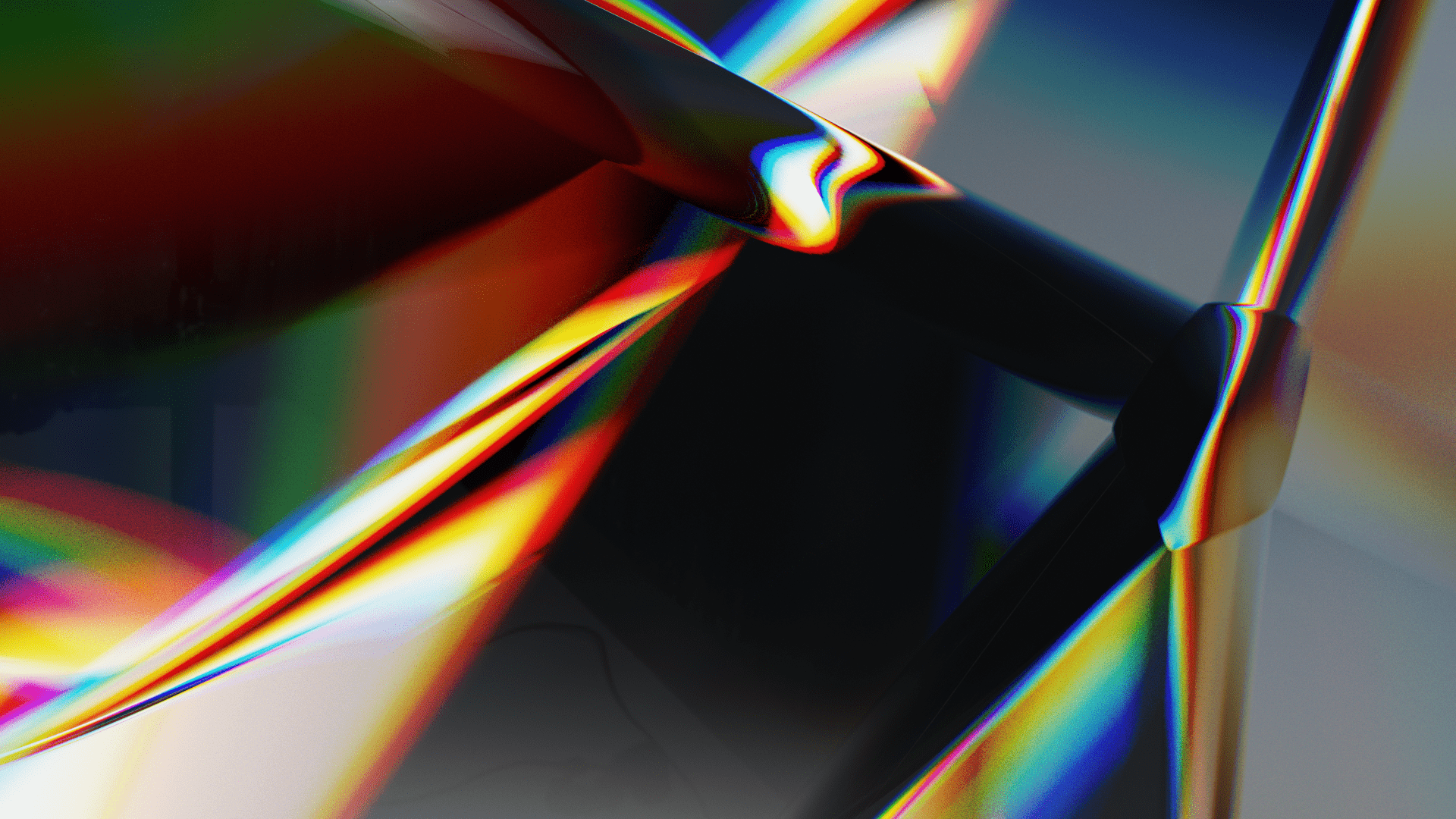 Close-up view of the surface of a glass crystal shard with light reflecting and reflacting off the surface producing a spectrum of varrying color.